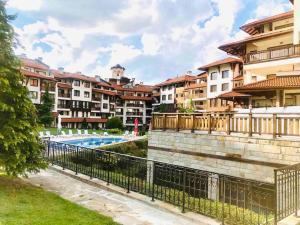 a row of apartment buildings with a swimming pool at Boutique lux design apartment @Bansko Royal Towers in Bansko