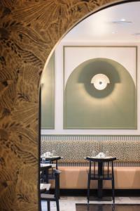 a dining room with two tables and a large window at Hotel Khla Nice in Nice