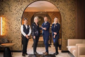 a group of people standing in front of a doorway at Hotel Khla Nice in Nice