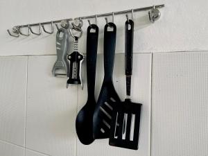 a group of kitchen utensils hanging on a wall at 103/24 Kathu Waterfall in Phuket
