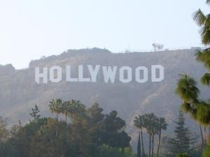a hollywood sign on top of a mountain with palm trees at Cute Studio in the Heart of Hollywood in Los Angeles