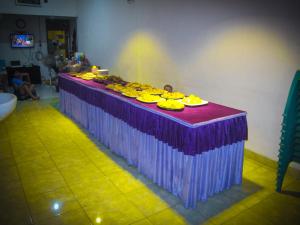 a purple table with plates of food on it at MOANA INN in Karimunjawa