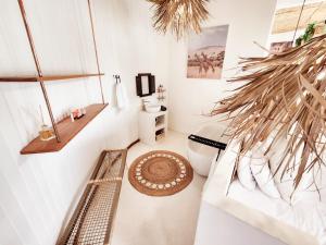 a bathroom with a toilet and a bench in it at Buff & Fellow Eco Cabins in George +255 photos