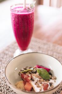 a bowl of food on a table with a drink at The Room Padang-Padang in Uluwatu