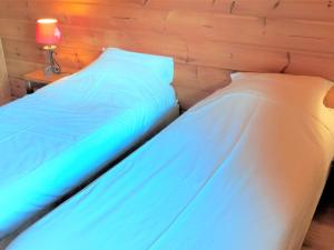 two beds sitting next to each other in a bedroom at Chalet La Joue du Loup, 3 pièces, 6 personnes - FR-1-504-638 in Le Dévoluy