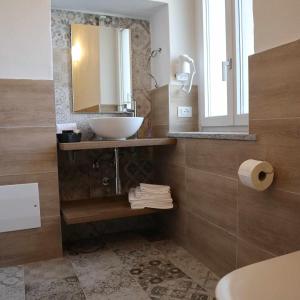 a bathroom with a sink and a mirror at La Bolgora Guesthouse in Novara