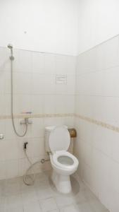 a bathroom with a toilet and a shower at The Kirana Purnama Semarang in Semarang