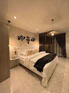 a bedroom with a large white bed in a room at The Lennox Luxury Apartment in Accra