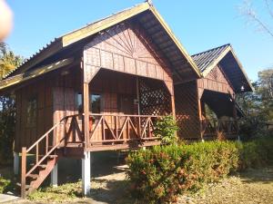 a wooden house with a porch and a deck at Sainamhai Resort in Ban Namsanam