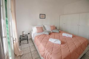 a bedroom with a large bed with two pillows on it at Ionian Luxury Apartments in Perama