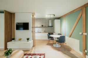 a kitchen and dining room with a table and chairs at Academy Home in Focşani