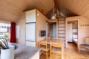 a kitchen and dining room in a tiny house at Velling Koller Hotel og Camping in Bryrup