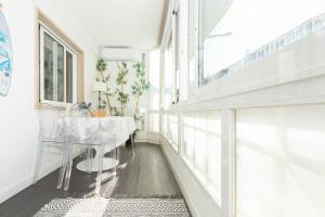 a hallway with a table and chairs in a house at Beachome4u in Carcavelos