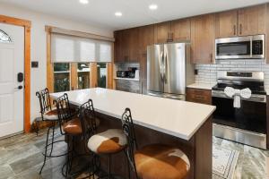 a kitchen with a large island with chairs in it at Winterset 8 Pet Friendly townhouse in Steamboat Springs