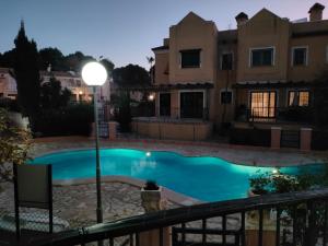 a swimming pool in front of a house at night at House Laguna Roja in Torrevieja