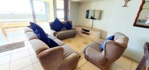 a living room with couches and a flat screen tv at La Mer 12 - 9 Sleeper - Stylish & Sophisticated! in Margate