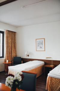 Ένα ή περισσότερα κρεβάτια σε δωμάτιο στο Hotel Tunneli