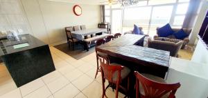 a living room with a table and chairs at La Mer 12 - 9 Sleeper - Stylish & Sophisticated! in Margate