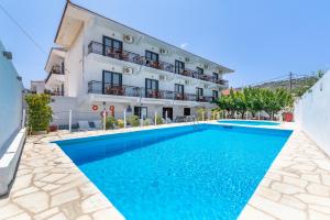 a villa with a swimming pool in front of a building at Amalia2 in Skopelos Town