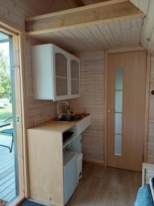 a kitchen in a tiny house with a sink at Päikesemajake 2 in Soonlepa