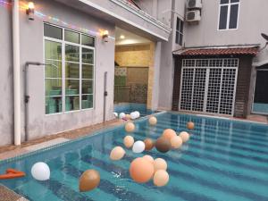 a pool with a bunch of balls in the water at Raihan Beach Resort in Dungun
