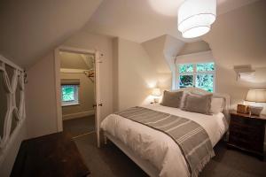 a bedroom with a large bed and a window at Fabulous Dartmoor House: Views, Turret, & Fire Pit in Lustleigh