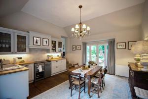 a kitchen with a table and a dining room at Fabulous Dartmoor House: Views, Turret, & Fire Pit in Lustleigh