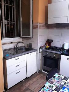 a small kitchen with a sink and a stove at Sweet BH Apt In Rome in Rome