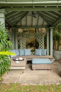 a patio with a table and a bench on a patio at 41 Lighthouse Street in Galle