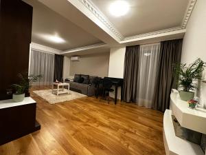 a living room with a couch and a table at Terrace apartments otopeni ! in Otopeni