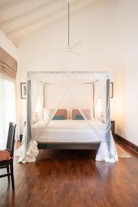 a bedroom with a bed with a canopy at 41 Lighthouse Street in Galle