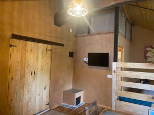 a room with a door and a television and a staircase at Sons do Eo Apartamentos Turísticos in Baleira