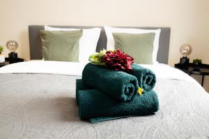 a pile of towels sitting on top of a bed at Luxury Rooms in Antwerp