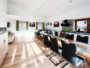 a large living room with a long table and chairs at Wildgrün in Pfronten