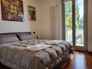 Ένα ή περισσότερα κρεβάτια σε δωμάτιο στο Residence Belvedere Apartment Volesio +70 φωτογραφίες
