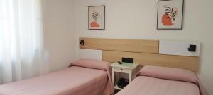 Postel nebo postele na pokoji v ubytování Hostal Bahía