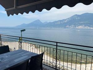 a view of the beach and the ocean from a balcony at Haus and Beach in Brenzone sul Garda