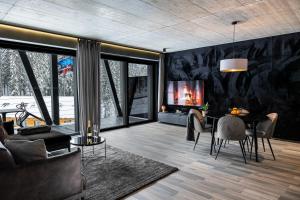 a living room with a table and a tv at BÚDA Jasná in Demanovska Dolina