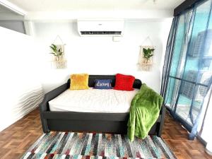 a bedroom with a bed with colorful pillows on it at Sea View 1br sleeps 4 in Fajardo