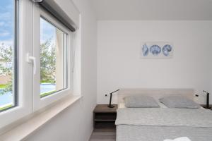 Ένα ή περισσότερα κρεβάτια σε δωμάτιο στο Apartmani Villa Ruby 2 +56 φωτογραφίες