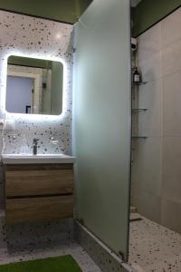 a bathroom with a sink and a mirror at Zhalgin's apartments 2 in Turksib