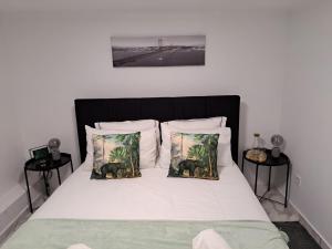 a bedroom with a bed with two elephants pillows at Costa Paradise Beach in Costa da Caparica