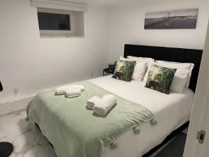 a bedroom with a large bed with towels on it at Costa Paradise Beach in Costa da Caparica