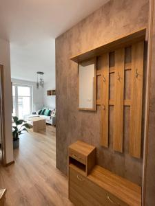 a living room with wooden cabinets and a couch at Vip Apartament LAUROWA in Tyczyn