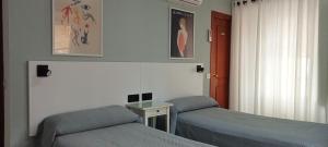 Postel nebo postele na pokoji v ubytování Hostal Bahía