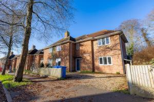 a brick house with a fence in front of it at 7 Bed House Pitchford Road in Earlham