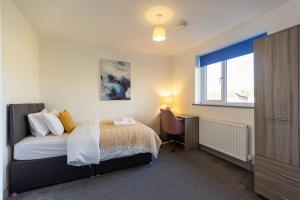 a bedroom with a bed and a window at 7 Bed House Pitchford Road in Earlham