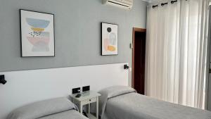 Postel nebo postele na pokoji v ubytování Hostal Bahía