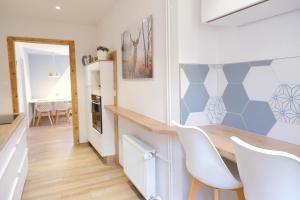 eine Küche und ein Esszimmer mit einem Tisch und Stühlen in der Unterkunft Appartement thématique: Nature Scandinave in Travers