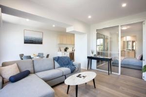 a living room with a couch and a table at Bendigo CBD Apartment in Bendigo